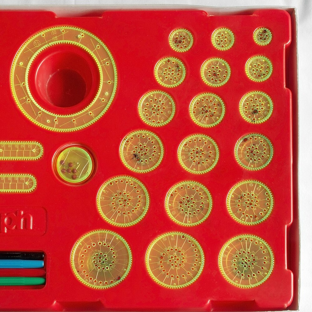 Estuche del Spirograph con todas las ruedas y anillos